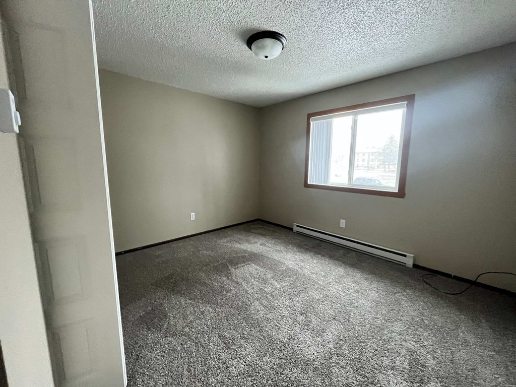 the living room of an empty house with a window
