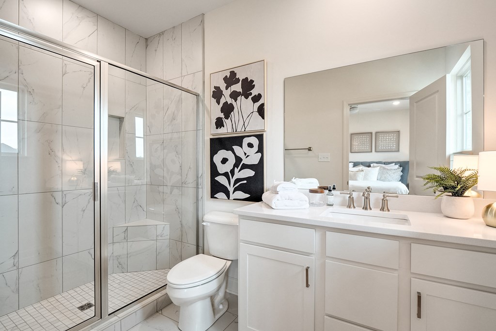 a bathroom with a shower and a sink and a toilet