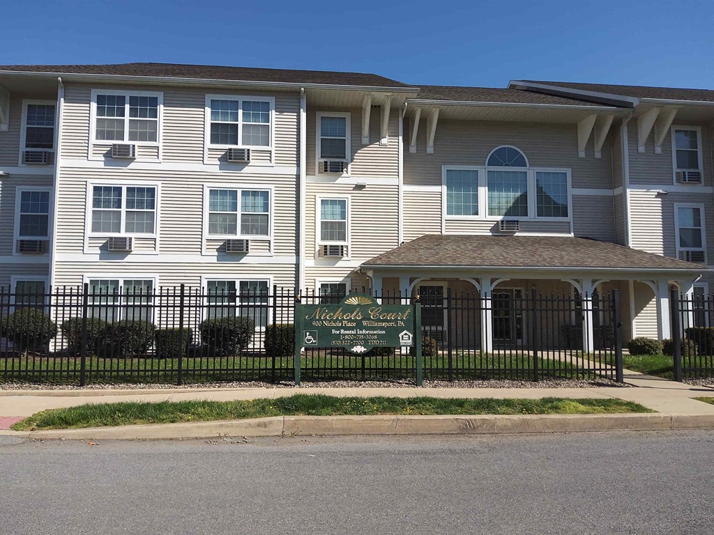 a large white building with a sign in front of it