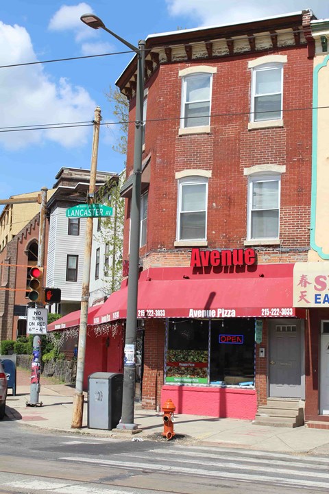 a restaurant on the corner of a building on a city street