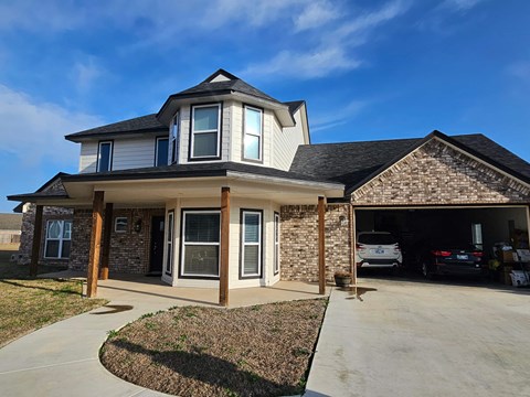 a house with a driveway and a car garage