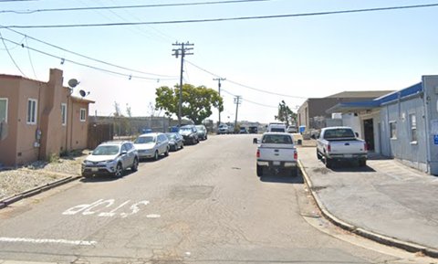 a city street with cars parked on the side of it