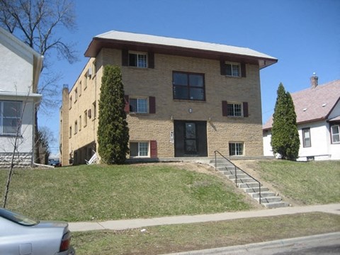 a large brick house on the side of a hill