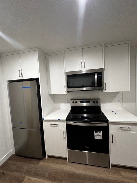 a kitchen with a stove and a refrigerator