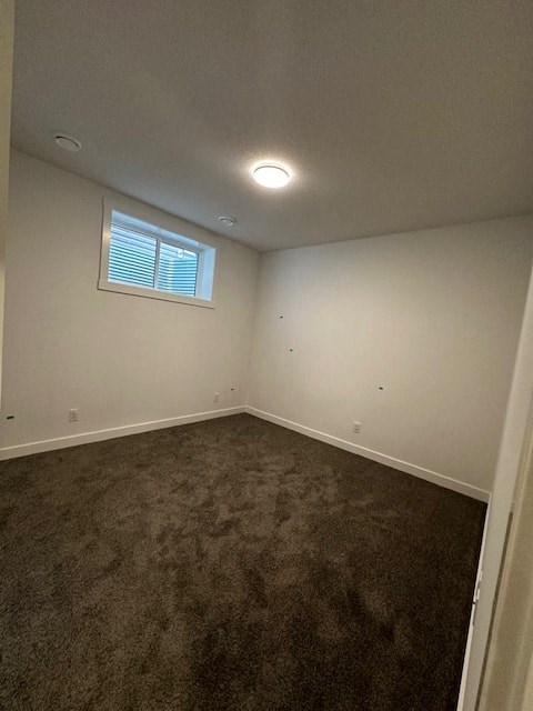 an empty room with carpet and a window