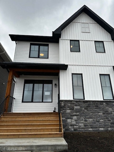 a white house with a wooden porch and stairs