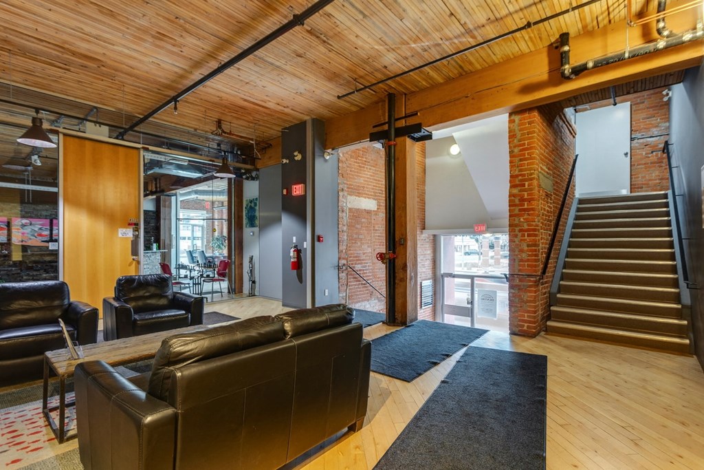 A large room with a staircase and a couch.