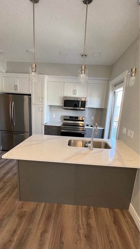 a kitchen with a counter top and a sink