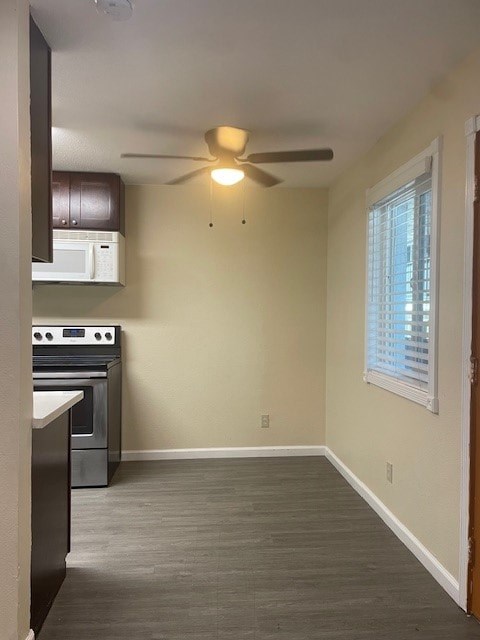 A kitchen with a stove top oven and microwave.