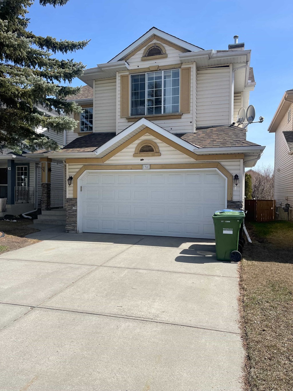 a white garage door in front of a house