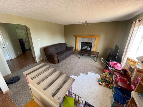 a living room filled with furniture and a fireplace