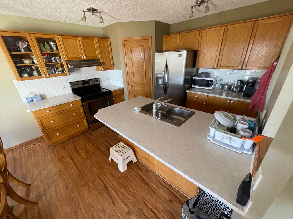 an aerial view of a kitchen with wooden cabinets