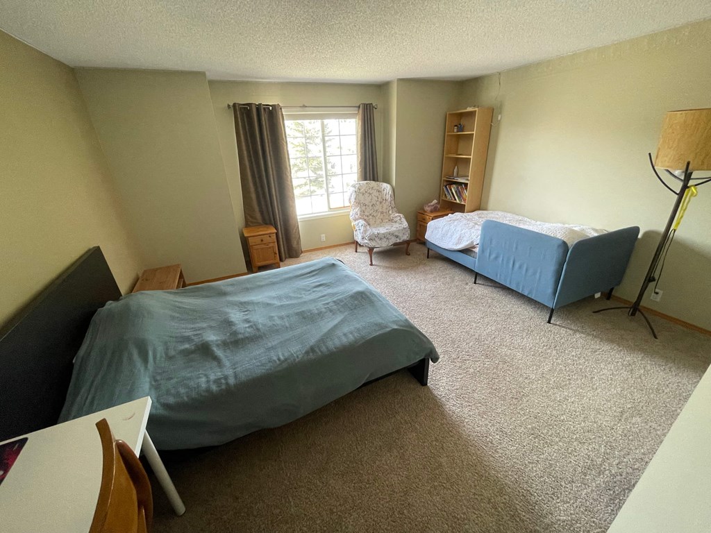 a bedroom with two beds and a couch