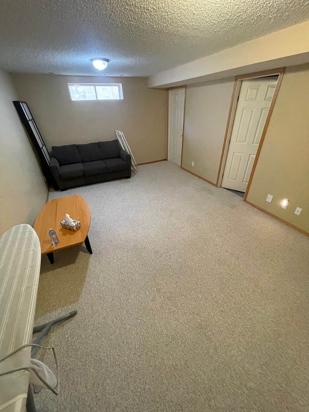 an empty living room with a couch and a table