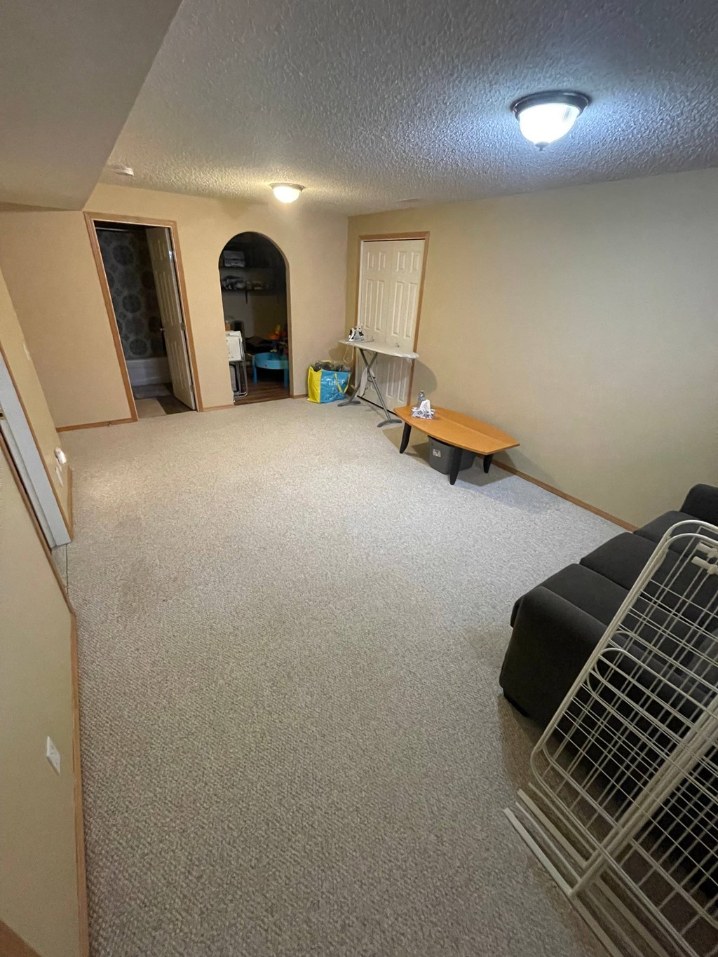 an empty living room with a couch and a table