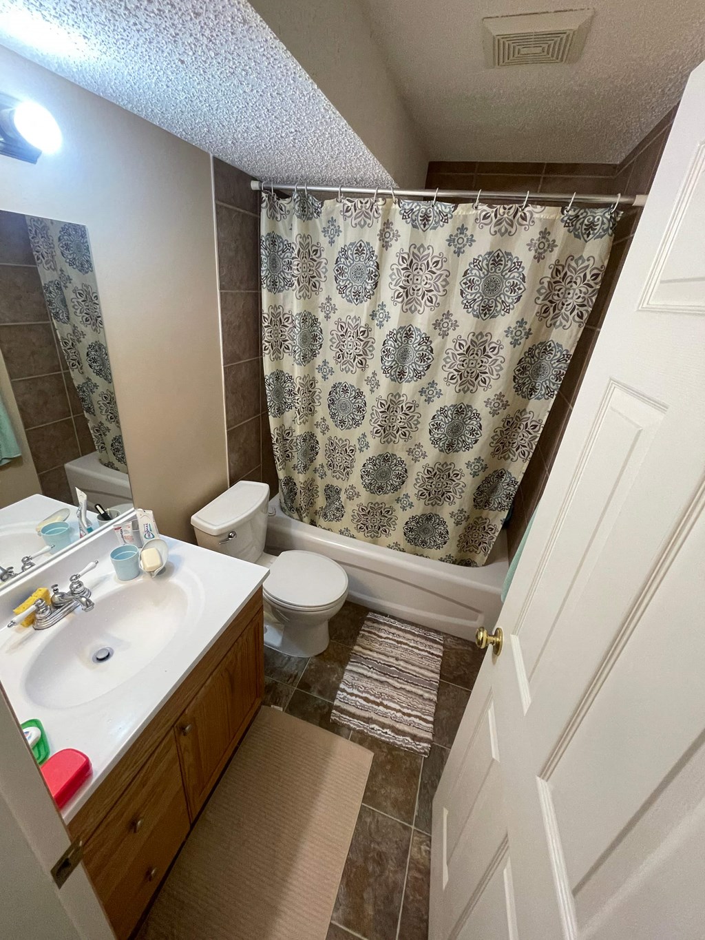 a bathroom with a shower and a sink and a toilet