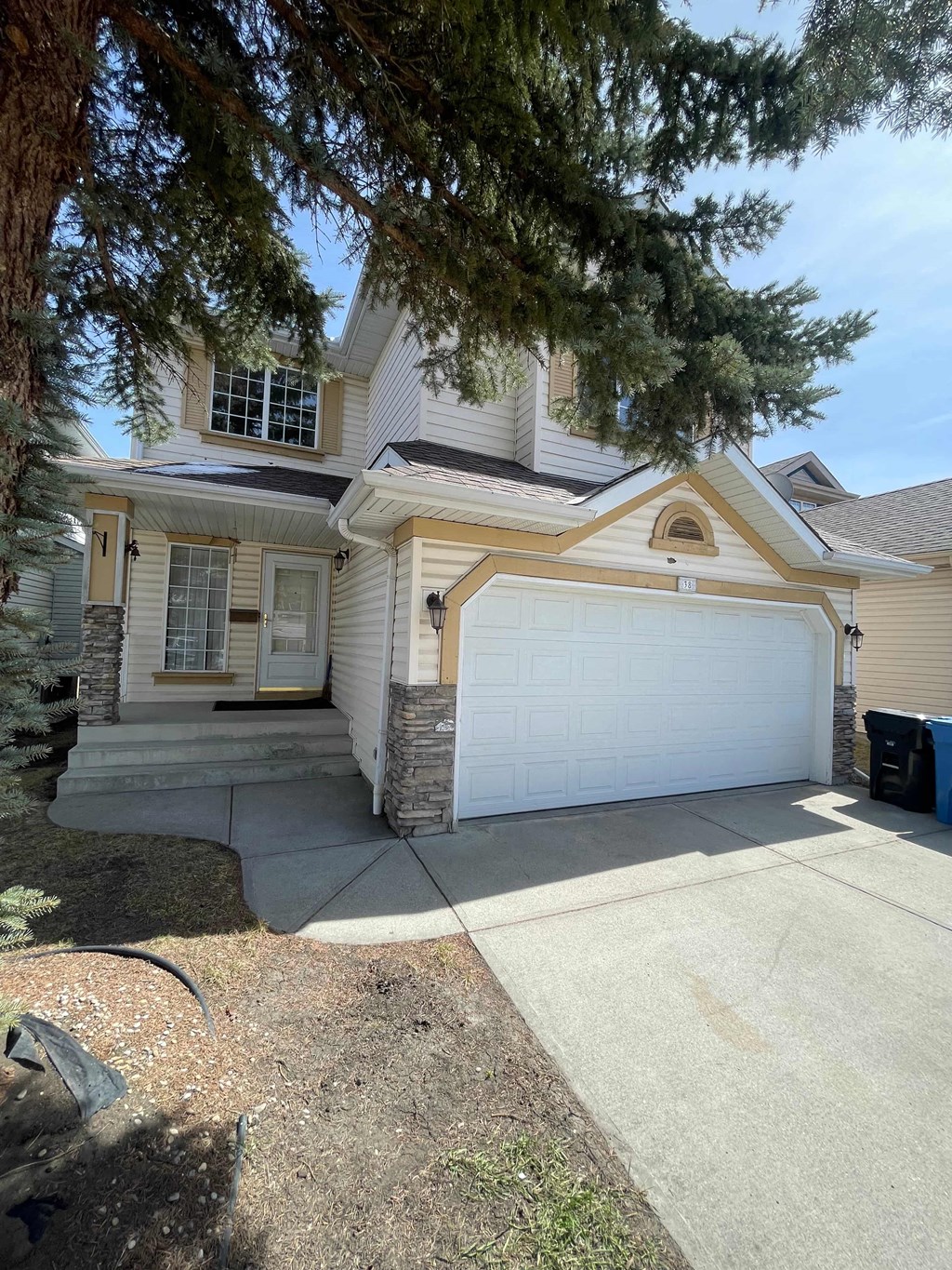 a house with a white garage door in front of it