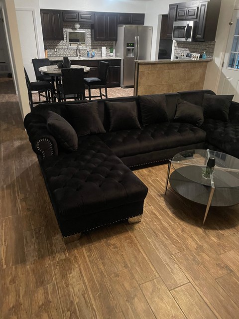 a living room with a leather couch and a table