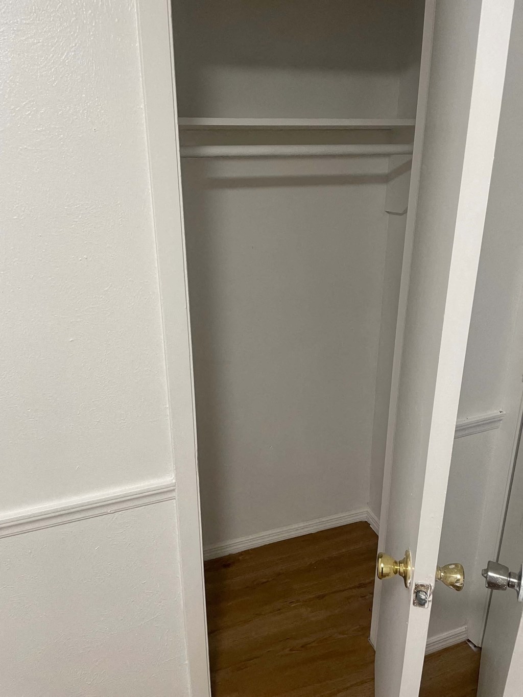 the door to the closet is open and the room is empty