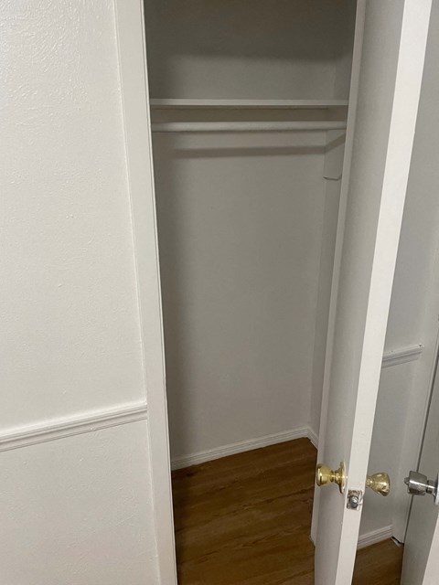 the door to the closet is open and the room is empty