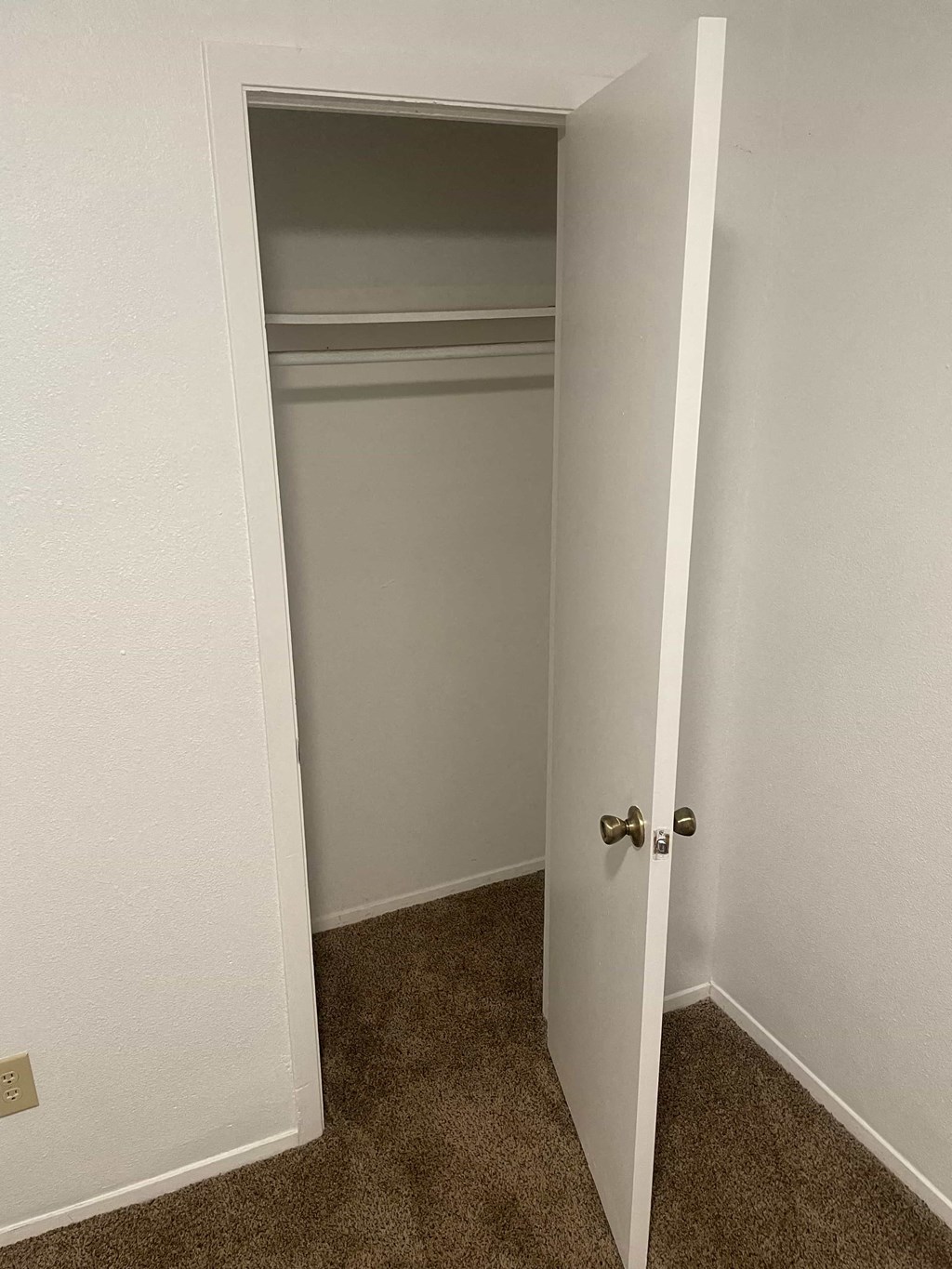 a room with a closet and an open door