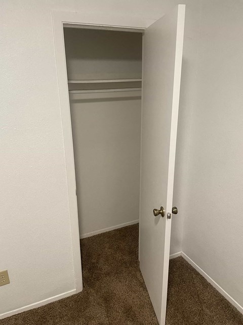 a room with a closet and an open door