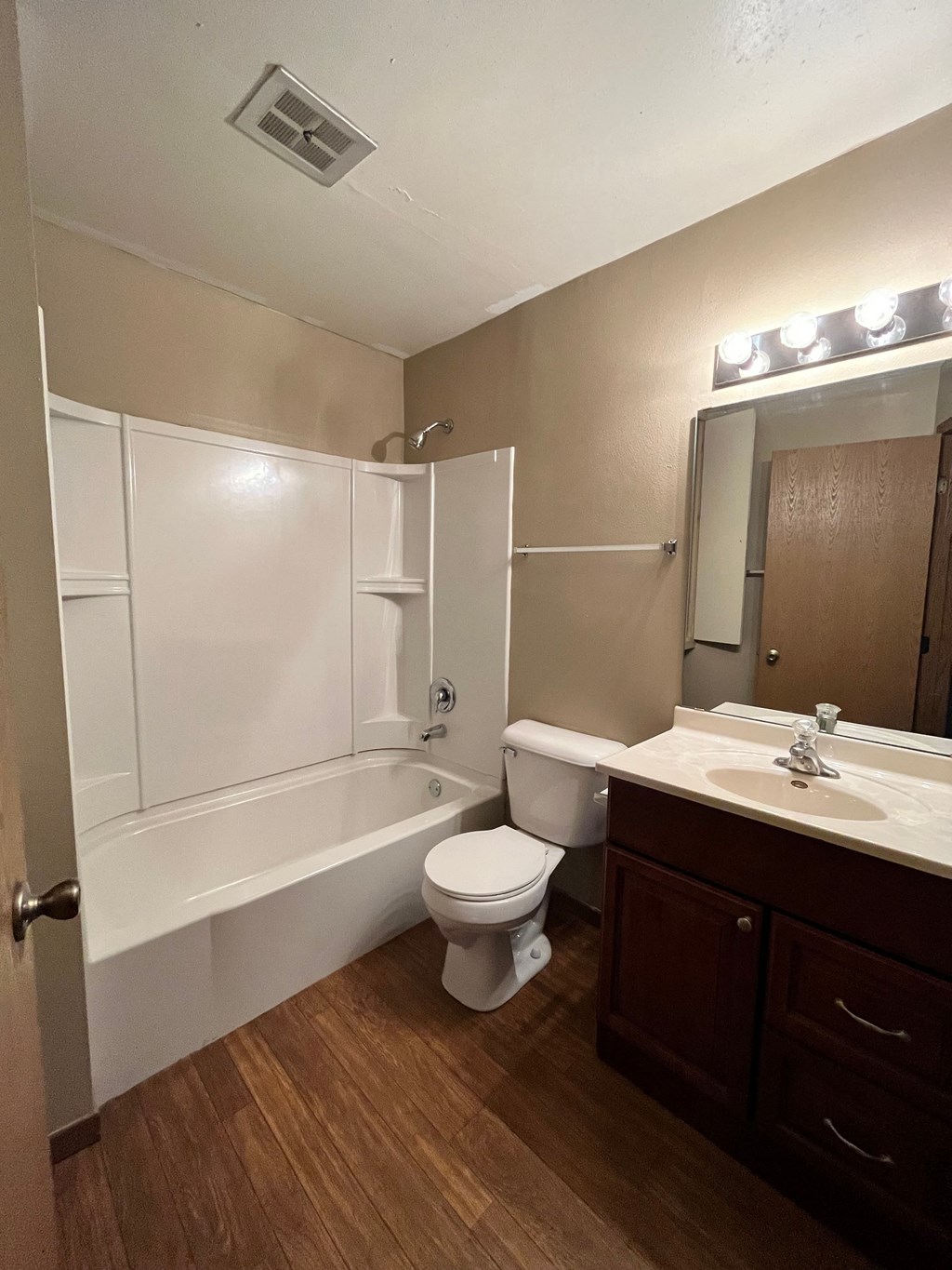 a bathroom with a toilet and a tub and a sink