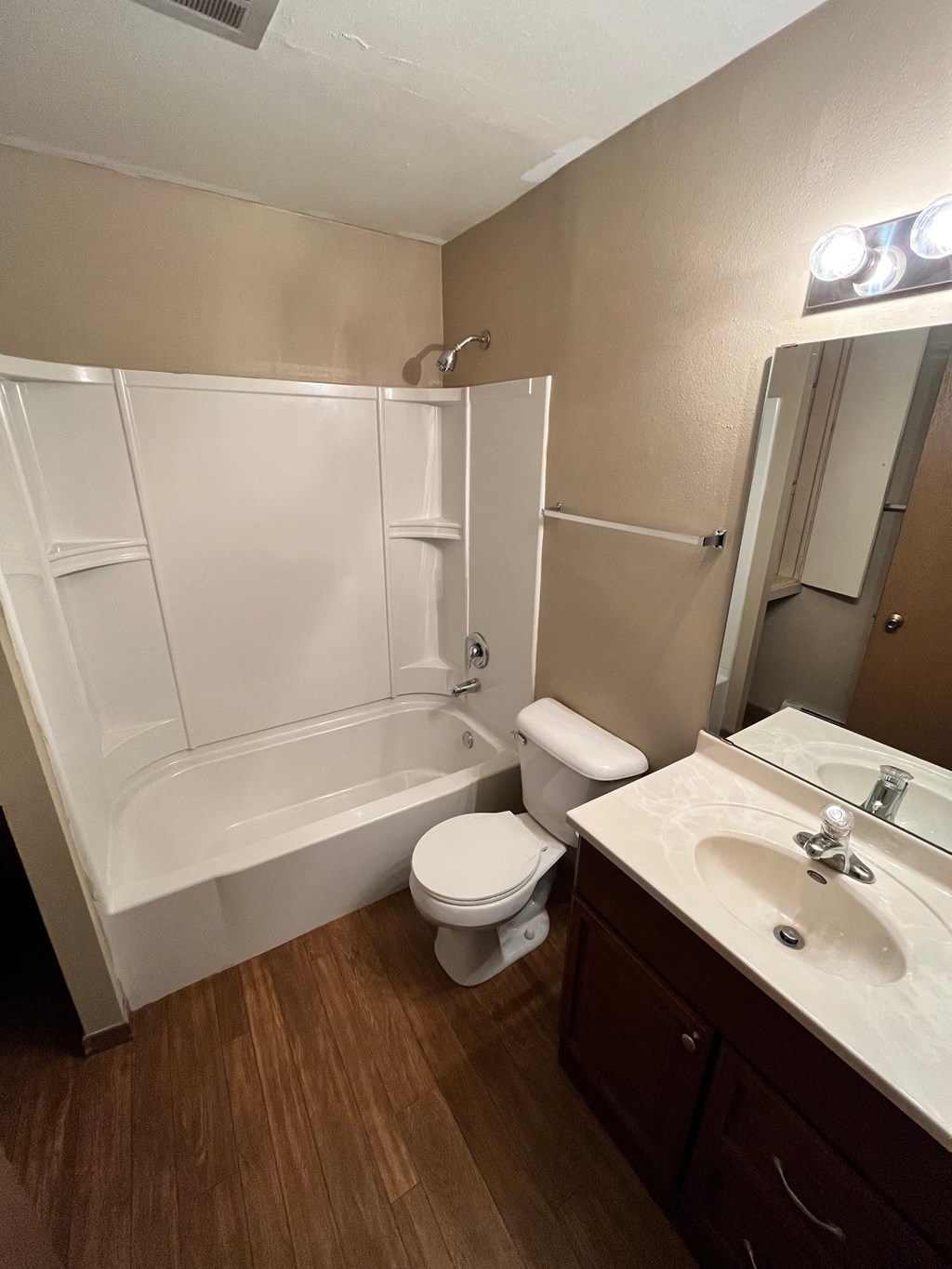 a bathroom with a shower toilet and sink