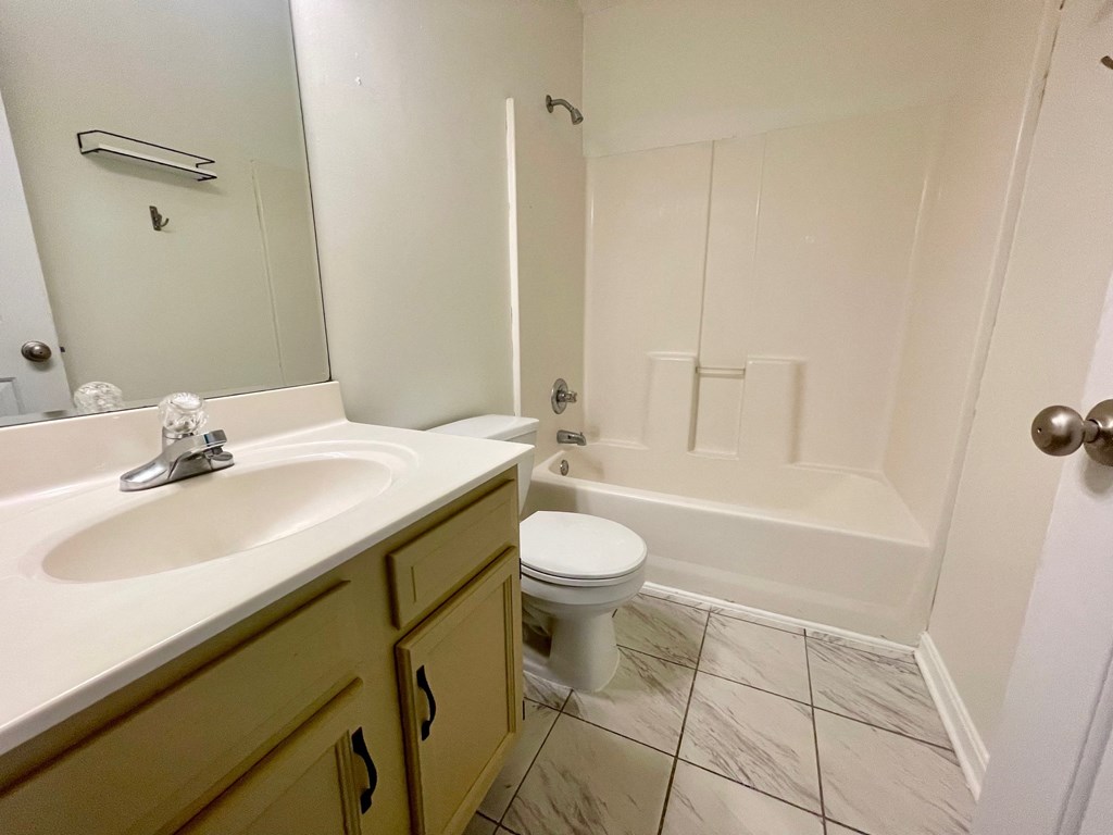 a bathroom with a sink toilet and a tub