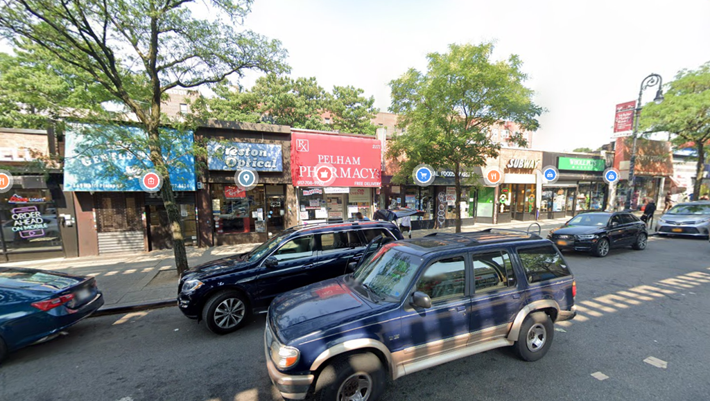 a busy city street with cars driving down it