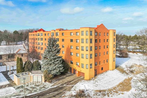 a large orange apartment building in the snow