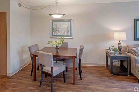 a dining room with a table and chairs and a couch