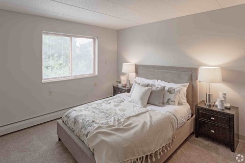 a bedroom with a bed and a window