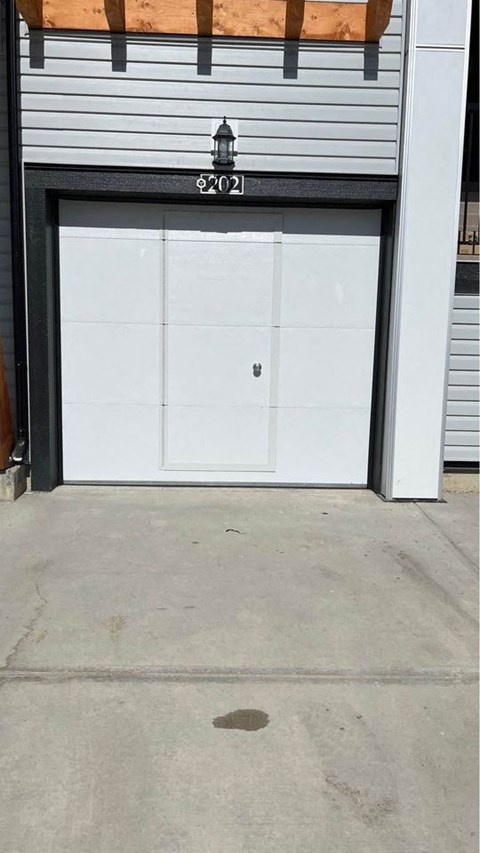 a white garage door in front of a building
