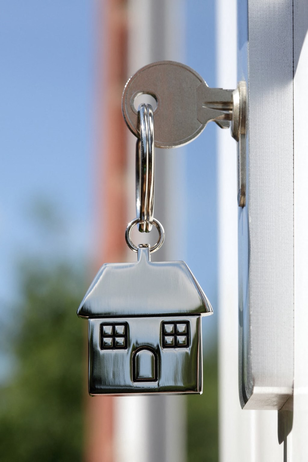 a house door key hanging on a door handle