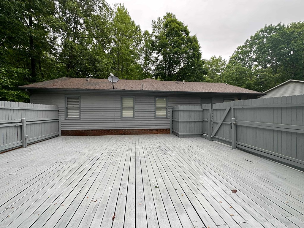 a back deck with a house in the background