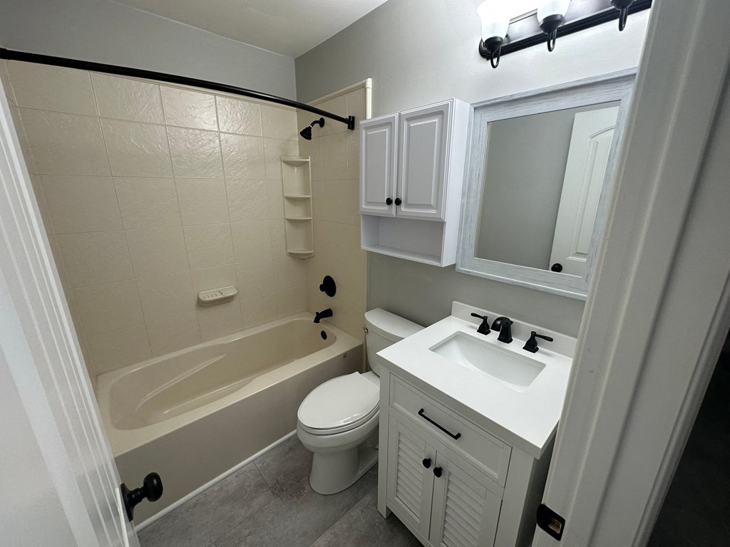 a bathroom with a sink toilet and tub