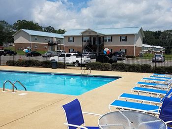 sparkling pool with lounge chairs and tables
