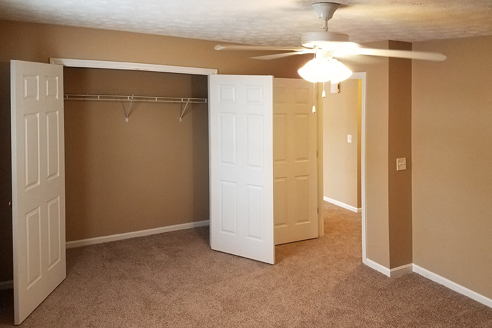 bedroom with fan and large closet