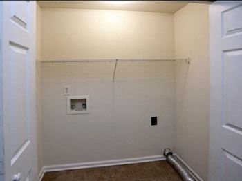 washer and dryer closet with built-in wire shelves