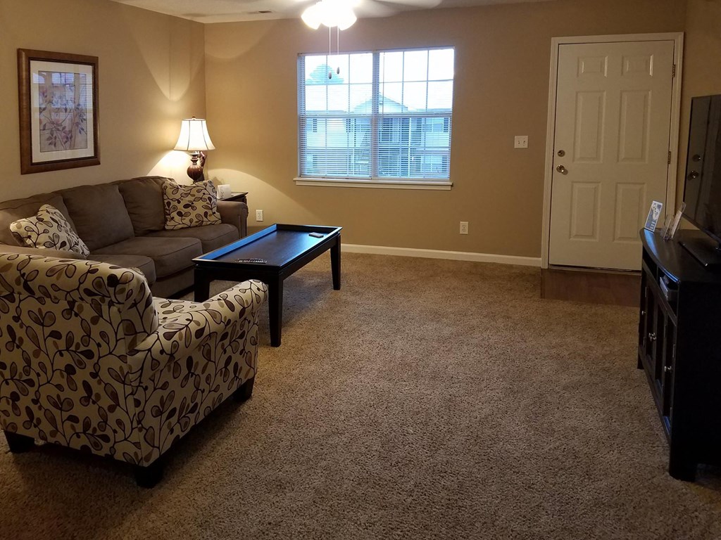 living room with fan and model furniture