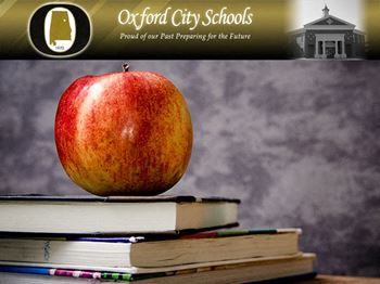 apple perched on top of stack of books