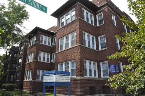 a large brick building with a sign in front of it