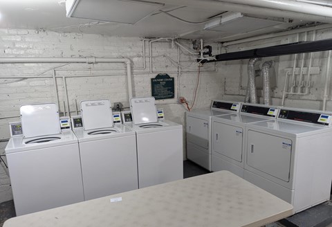 A row of washing machines in a laundromat.