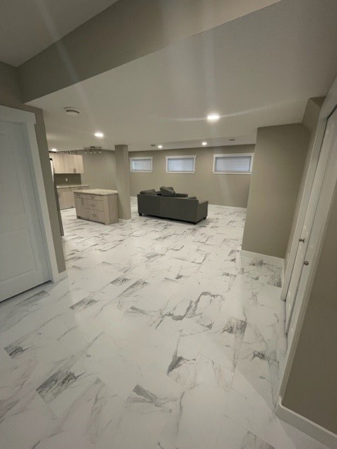 a living room with a marble floor and a couch