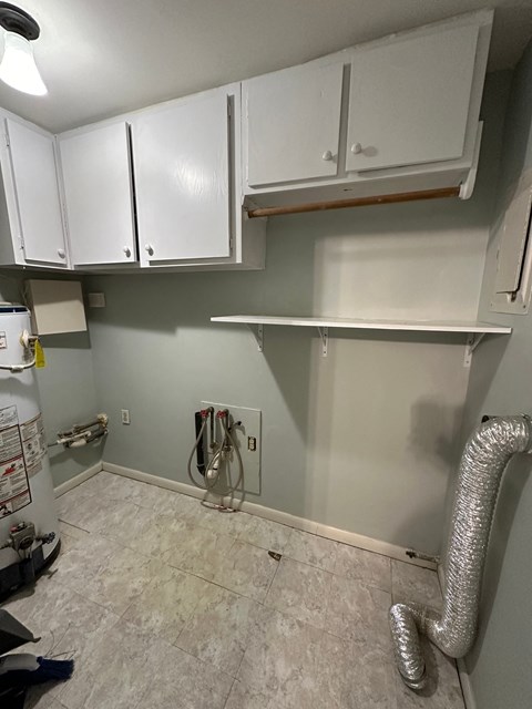 a kitchen is being remodeled with white cabinets and gray walls