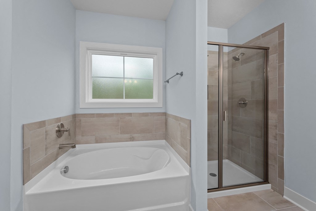 a bathroom with a tub and a shower