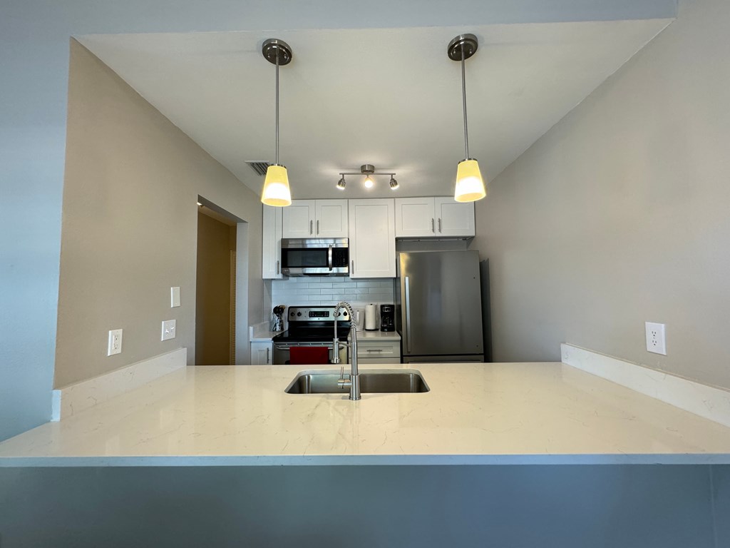 a kitchen with a large counter top and a sink