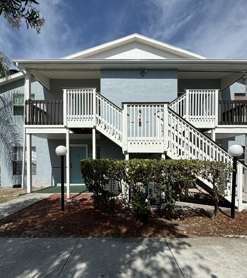 a house with a deck and a staircase