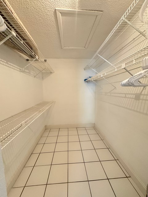 a laundry room with a tiled floor and a walk in closet